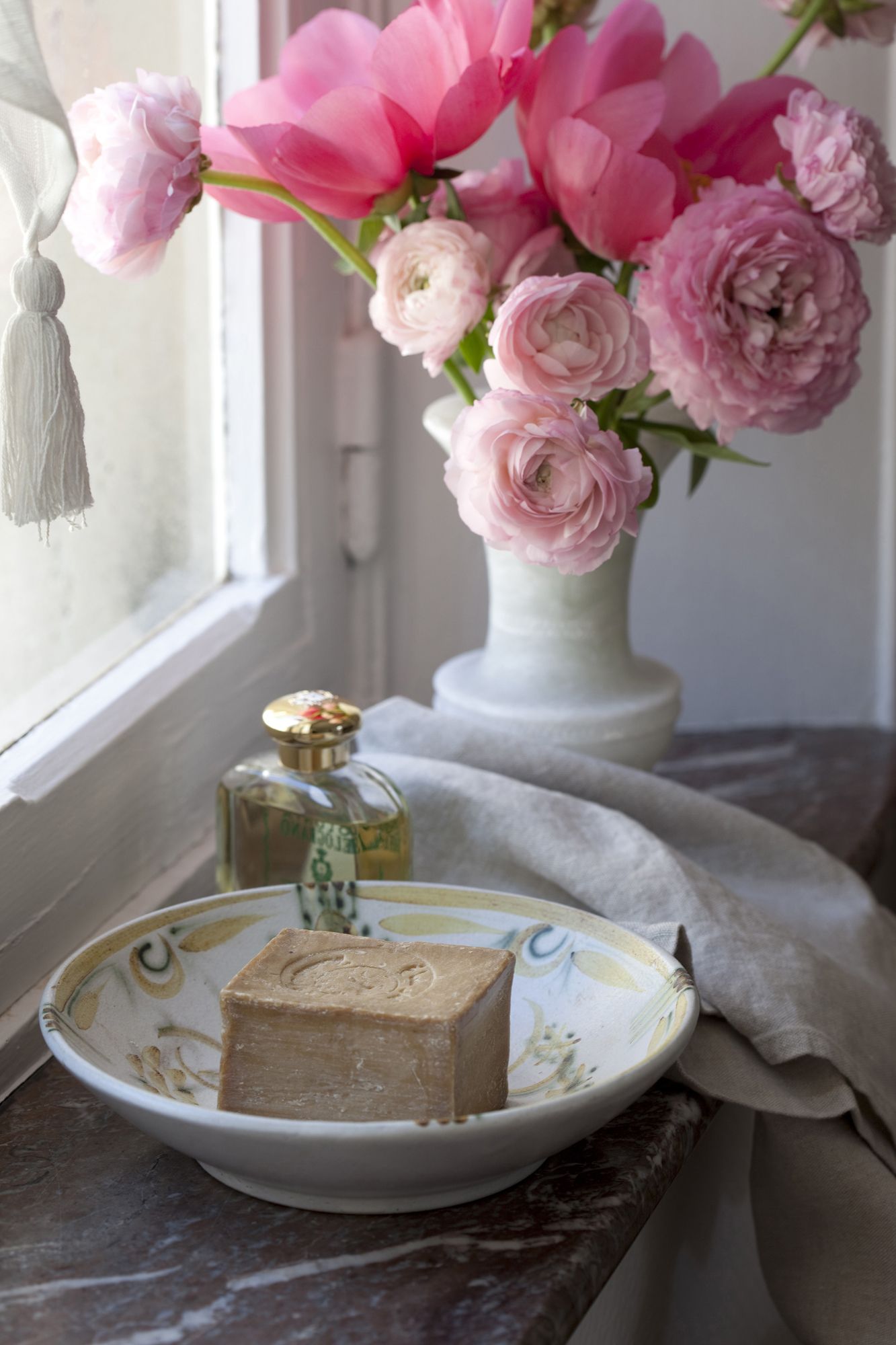 Senovinis muilo indas ir gėlės mažame vonios kambaryje